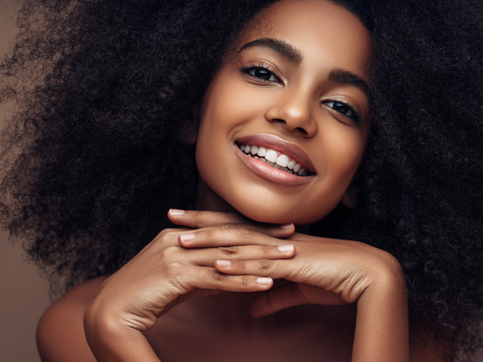 Beautiful smiling girl with curly hairstyle